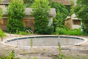Water drained inground pool. A partial pool removal is also known as a fill-in because the pool is filled