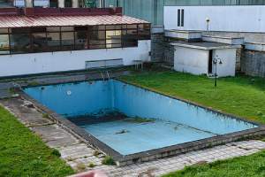 Abandoned empty swimming pool. Pool removal is a smart move for many homeowners
