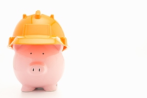 Piggybank with hard hat. There are factors that can influence the cost of pool removal