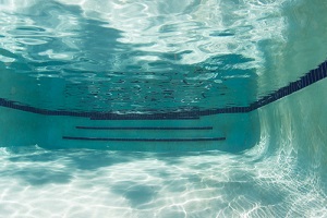 shadows playing across the surface and bottom of a swimming pool