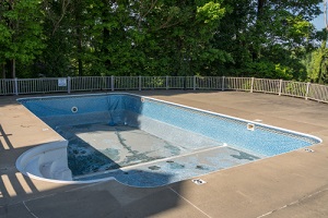empty in ground swimming pool ready for replacement