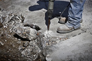 man drilling cement concrete road
