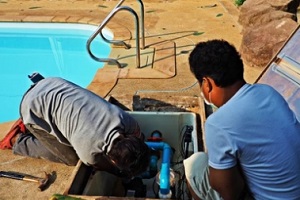 technicians removing the pool pump