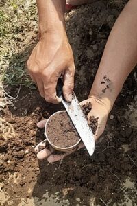 a man preparing soil for a proctor compaction test
