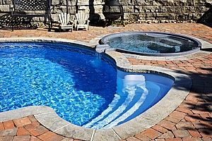 a pool with a hot tub being prepared for inground hot tub removal