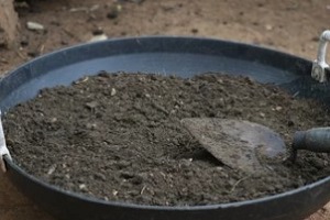 potting soil with trowel kept on basket