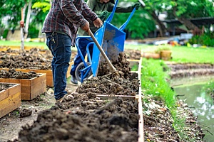 two men added soil to gardening beds