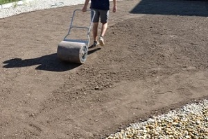 man filled swimming pool and moving soil compactor