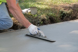 man installing concrete driveway