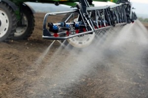 tractor spraying in soil