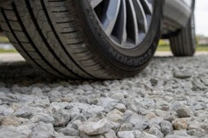 crushed limestone driveway under car tyre