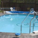 an above ground doughboy swimming pool surrounded by decking