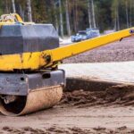 compact asphalt roller for tamping soil at a construction site