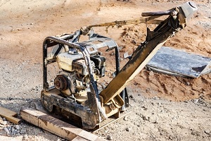 rammer with vibrating plate on a construction site