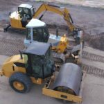 roller compactor and bulldozer on a construction site