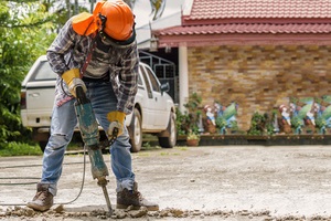 workers use electric concrete breaker