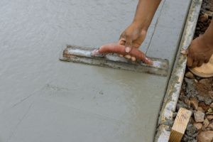 Applying trowel on wet concrete