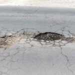Sinkholes and cracks in a driveway