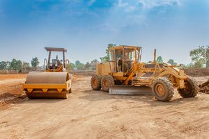 Soil compactor vehicles on a clay soil surface