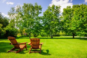 Two wooden chairs in a park, a sunny morning