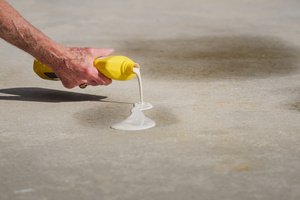 Applying stain remover on a concrete surface