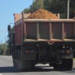 A dump truck carrying sand