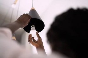 man applying led light to the bulb holder
