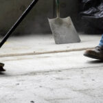 Northern Virginia construction worker sweeping up