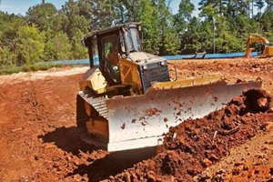 bulldozer pushing dirt while grading land with digger in Fairfax, VA