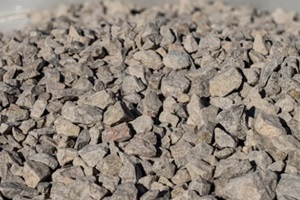 large pile of bulk #57 stone gravel sits ready to be used on a job site