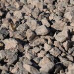 large pile of bulk 57 gravel sits ready to be used on a job site for a Northern VA DIY home improvement project