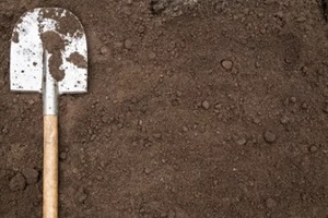 Northern VA bio mix soil ground texture background with copyspace and shovel on garden bed in farm garden