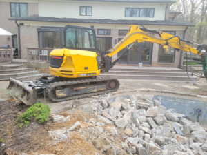 Pool Demolition Excavator In Action